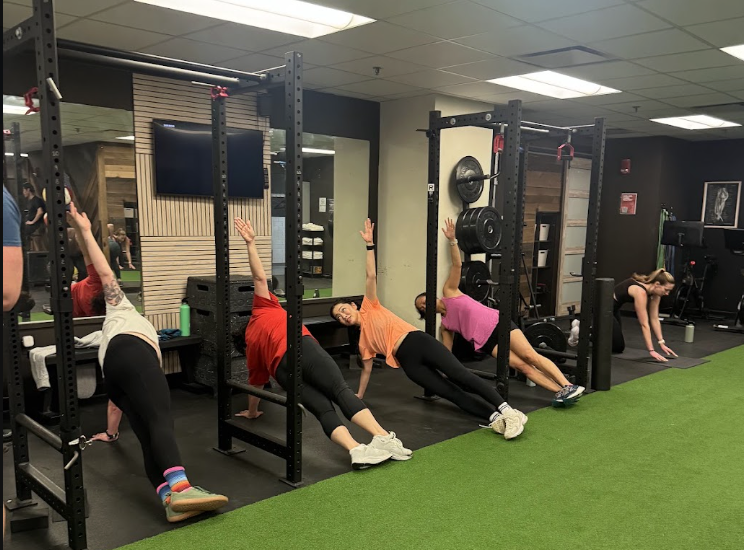 Small group side plank session at First Guess Fitness in Downtown Boston